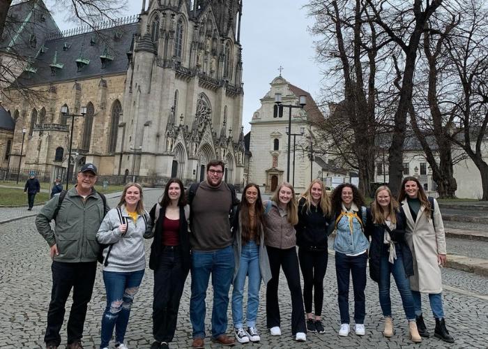 Group photo in front of a cathedral in the Czech Republic.